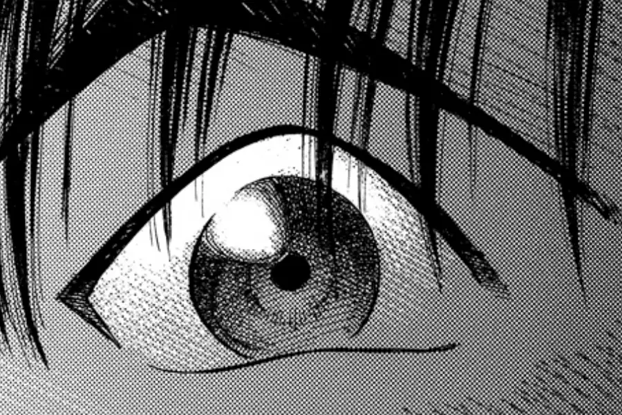 A close-up of an inked manga eye showing tapered hair strokes, cross-hatching in the iris, and a fine dot tone across the skin.